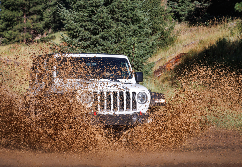 jeep driving through mud