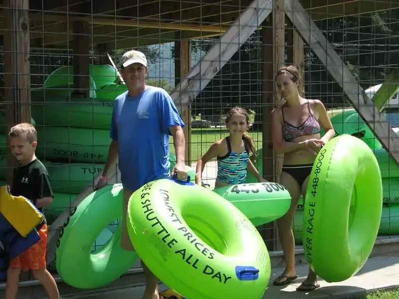 people grabbing inner tubes